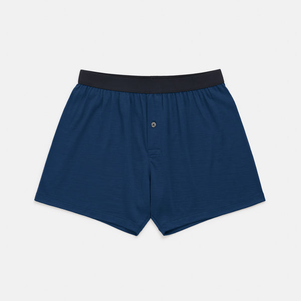 Laydown of merino wool boxer in Marine Blue, a deep royal blue color. This is a men's knit boxer short available in sizes XS-XXL. 