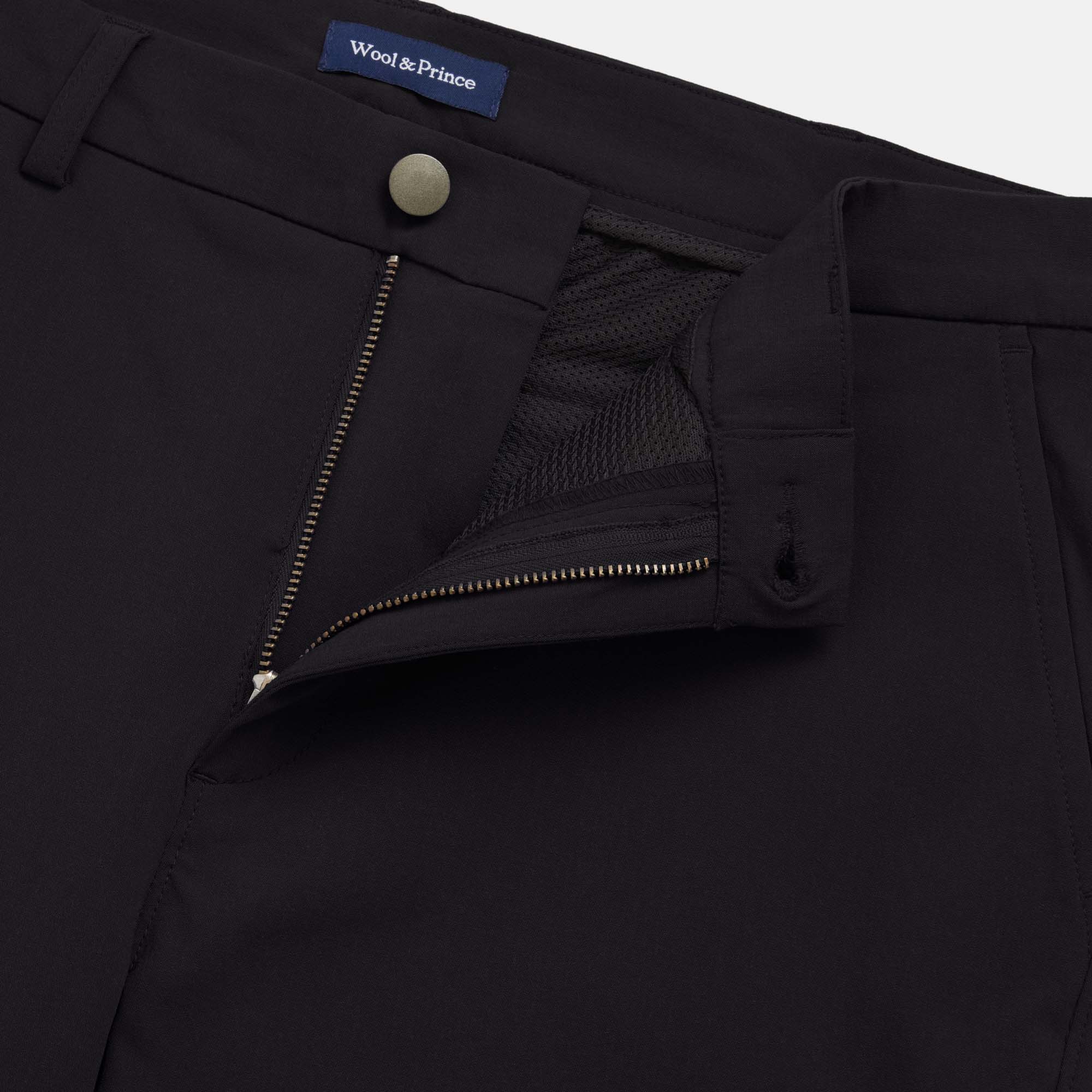 Detail of merino wool Stretch Tech Chino Pant in Black. This is a straight fit pant available in sizes 30-38.