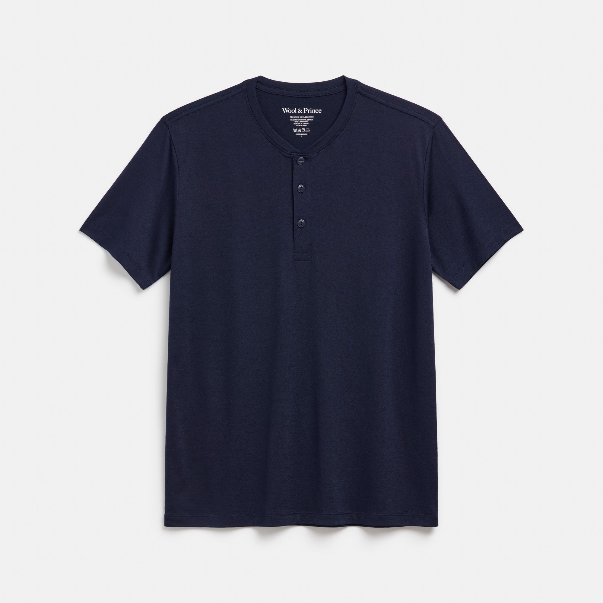 Laydown of merino wool Signature Short Sleeve Henley in Navy. This is a short sleeve, crew neck henley shirt available in sizes XS-XXL. 