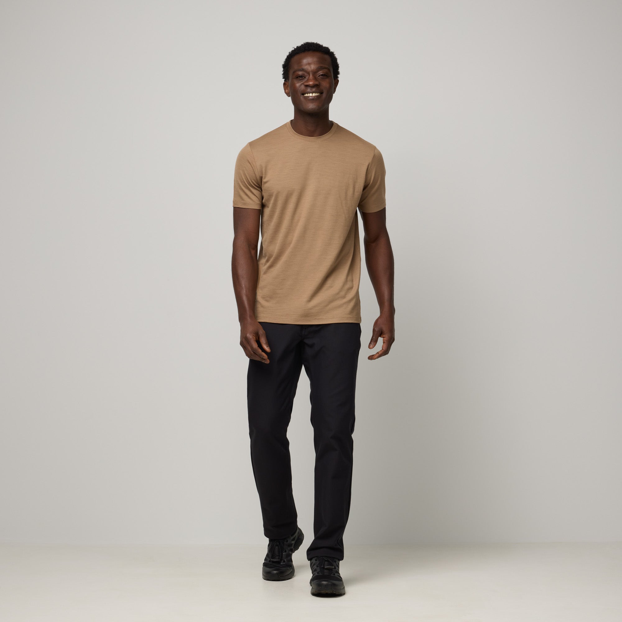 Model wearing 100% Merino Wool T-Shirt in Cedarwood, a warm soft brown color. This short sleeve, crew neck t-shirt is available in sizes XS-XXL.