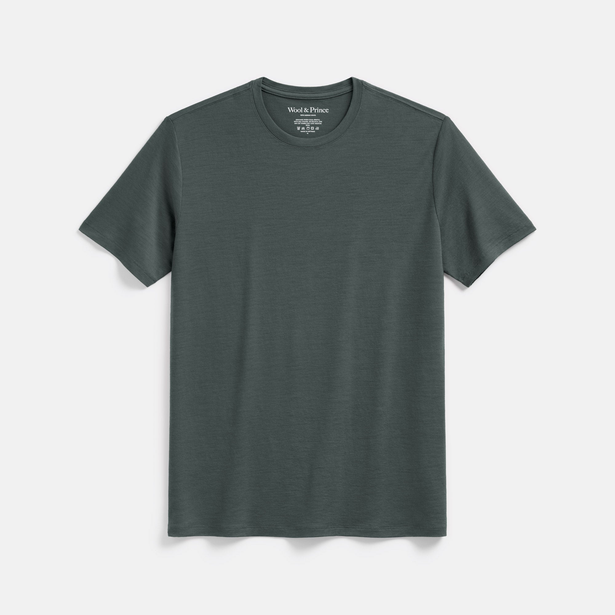 Laydown of 100% Merino Wool T-Shirt in Hunter Green, a dark green with blue undertones. This short sleeve, crew neck t-shirt is available in sizes XS-XXL.