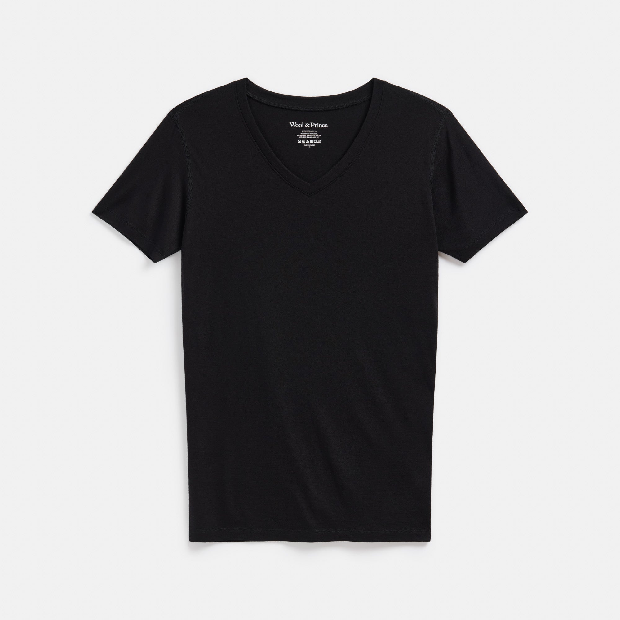 Laydown of 100% merino wool Undershirt in Black. This is a short sleeve, v-neck, lightweight undershirt available in sizes XS-XXL. 