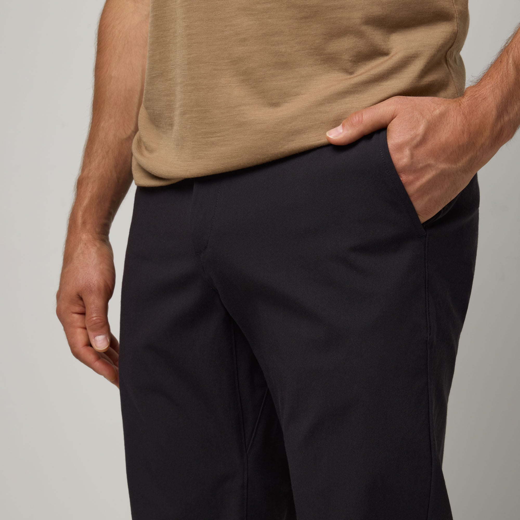 Model wearing merino wool Stretch Tech Chino Pant in Black. This is a straight fit pant available in sizes 30-38.