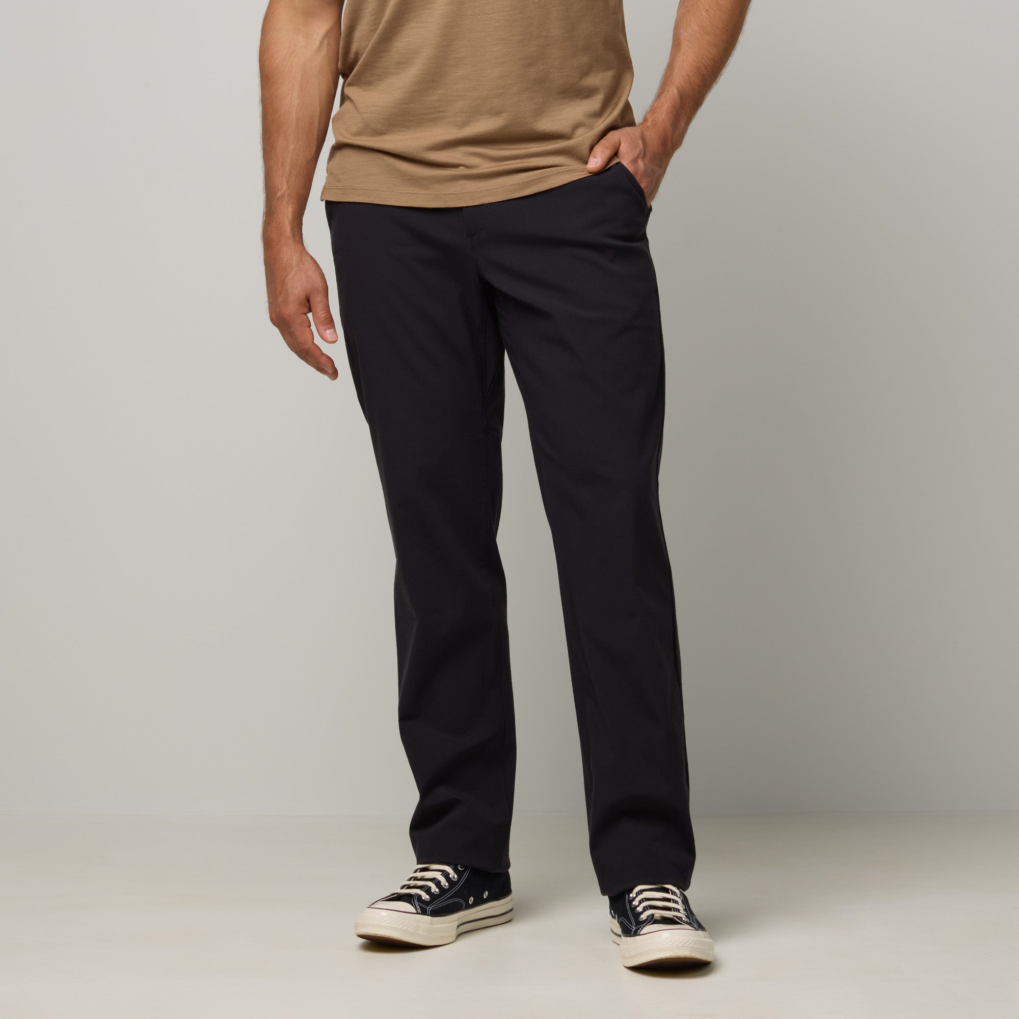 Model wearing merino wool Stretch Tech Chino Pant in Black. This is a straight fit pant available in sizes 30-38.