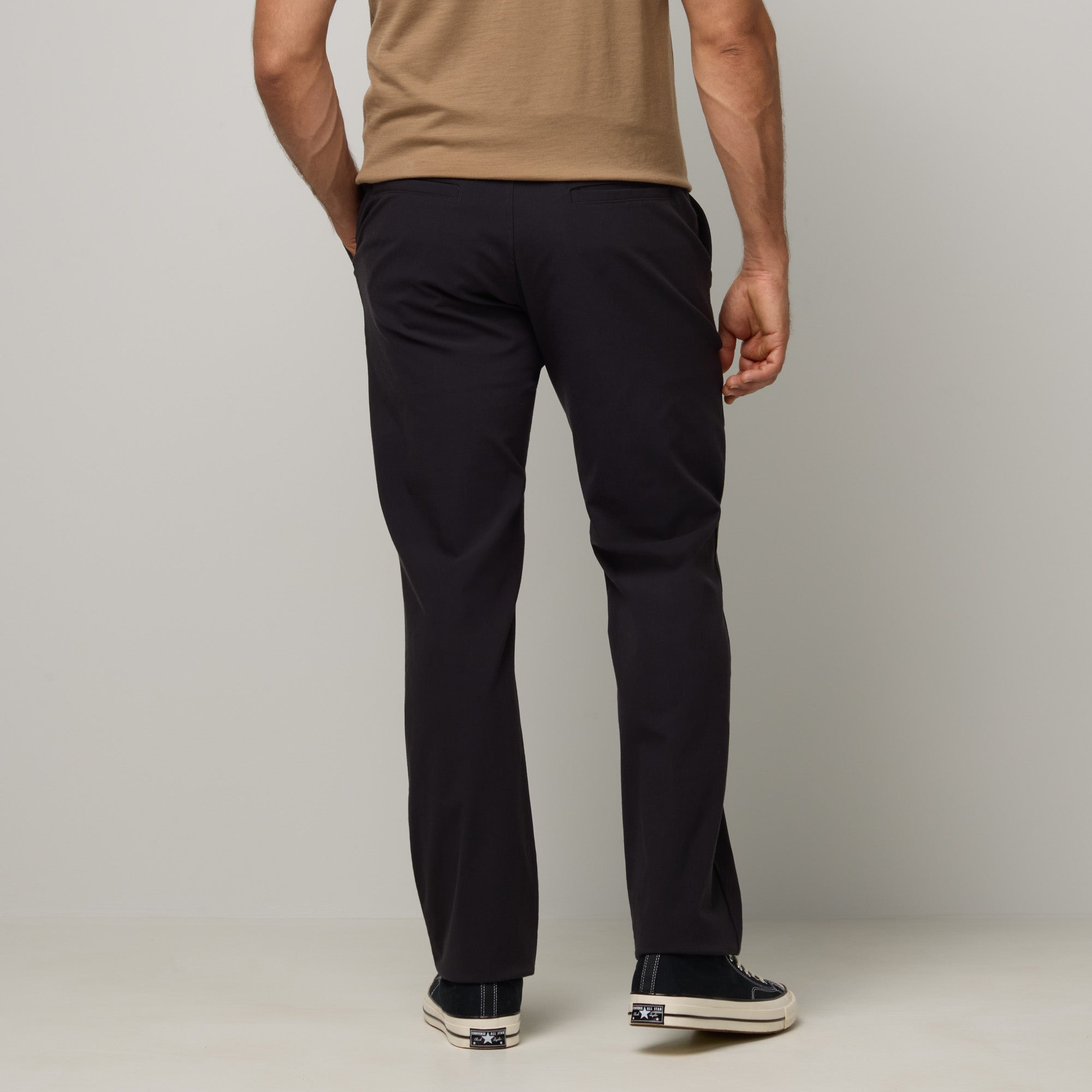Model wearing merino wool Stretch Tech Chino Pant in Black. This is a straight fit pant available in sizes 30-38.