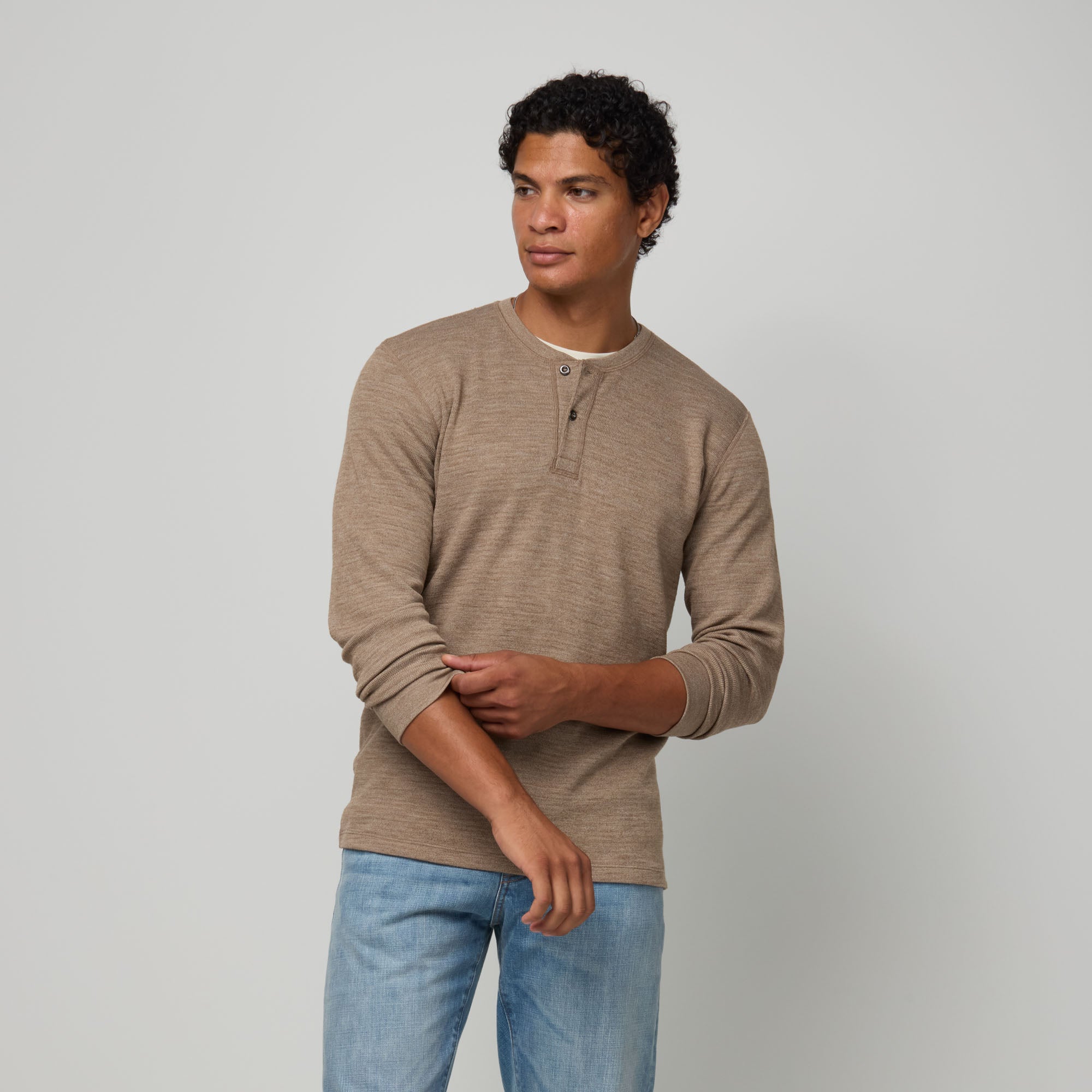 Model wearing merino wool Waffle Henley in Cedarwood Heather, a textured taupe-brown. This is a long sleeve, crew neck henley shirt available in sizes XS-XXL.