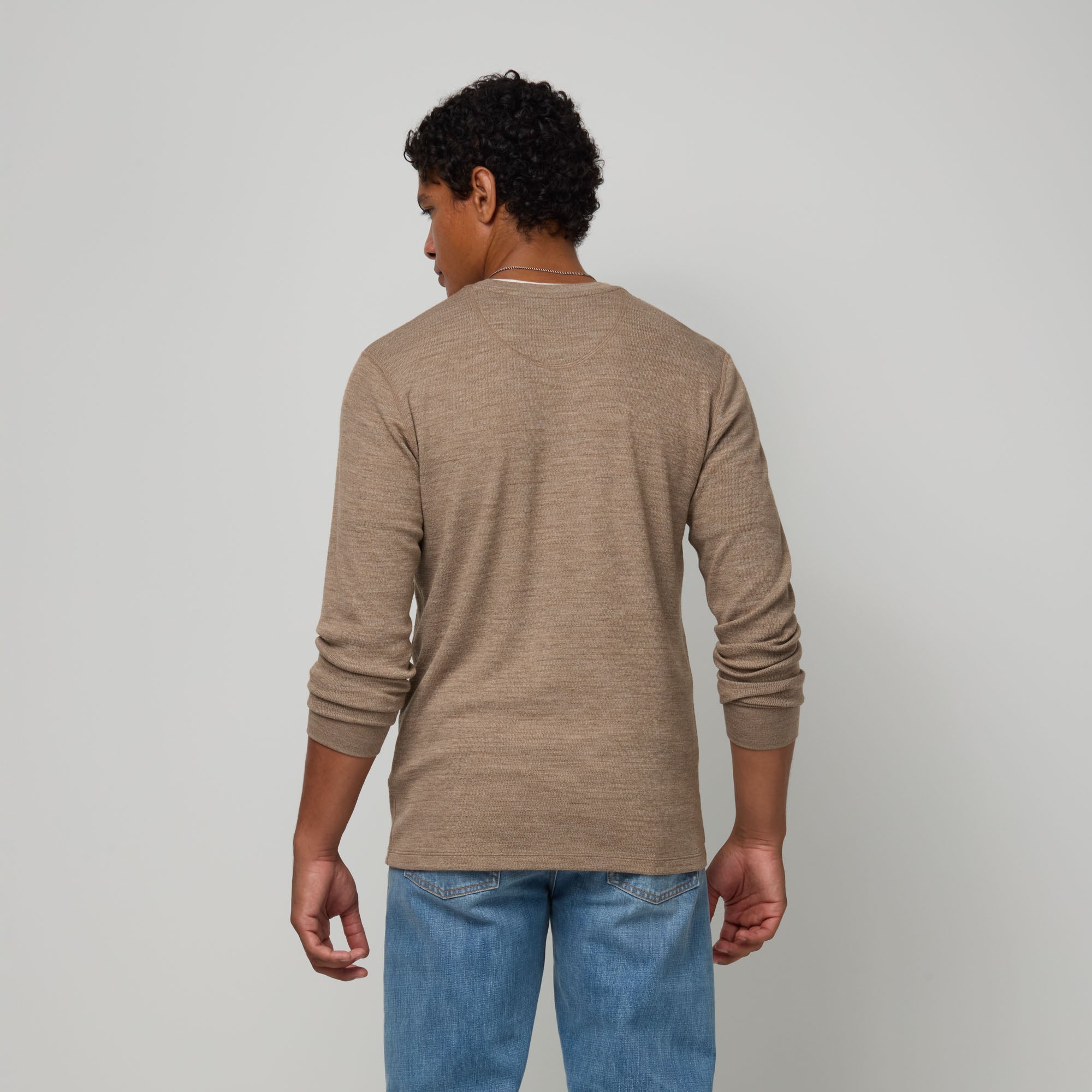 Model wearing merino wool Waffle Henley in Cedarwood Heather, a textured taupe-brown. This is a long sleeve, crew neck henley shirt available in sizes XS-XXL.