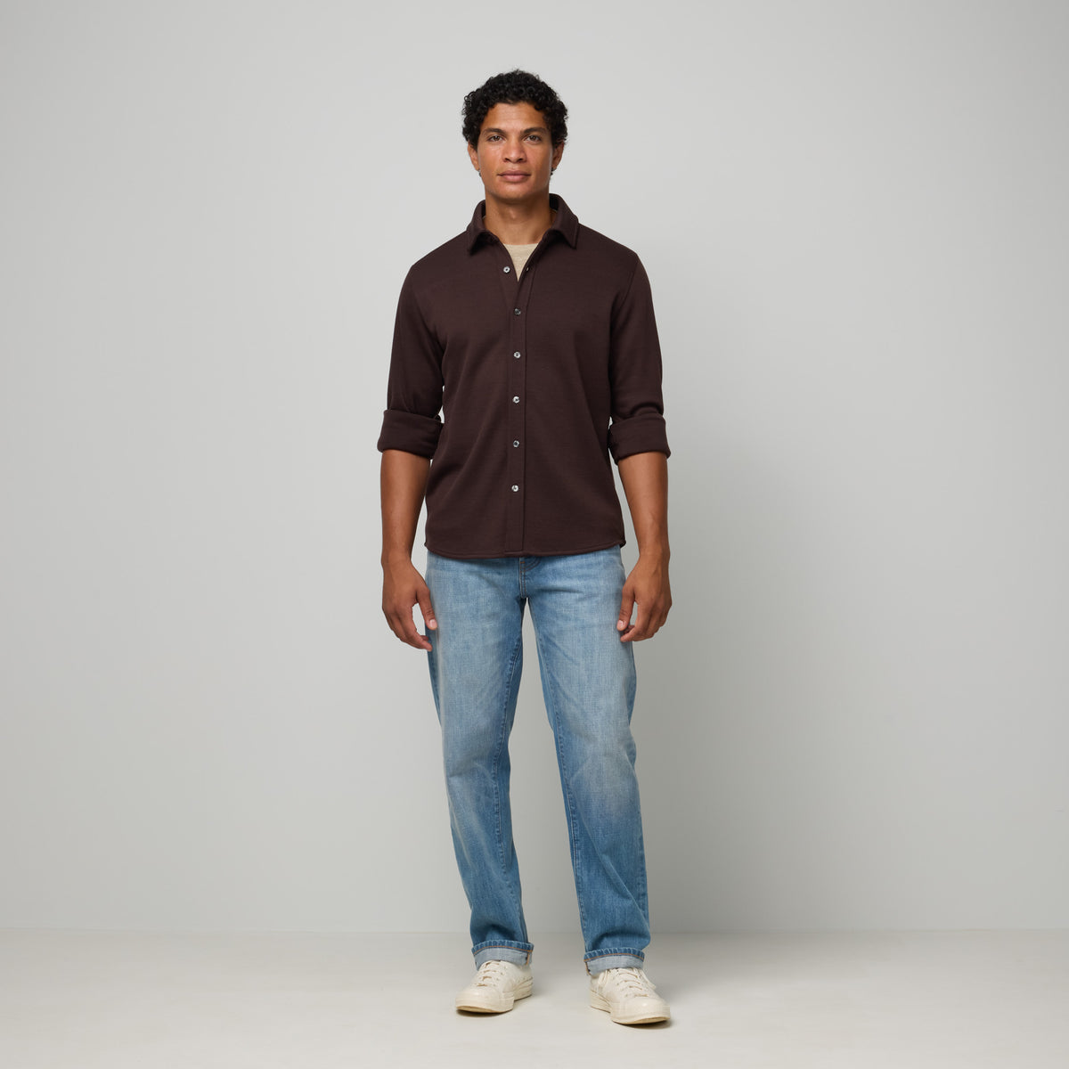 Model wearing merino wool Midweight Pique Button-Down Shirt in Espresso, a dark brown color. This is a long sleeve, collared, casual button-down shirt available in sizes S-XXL.