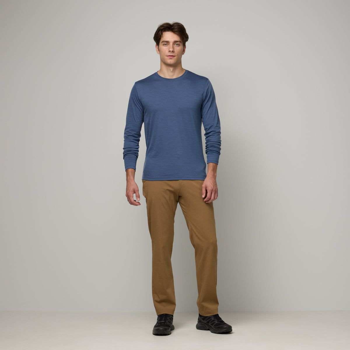 Model wearing merino wool Signature Long Sleeve Tee in Vintage Blue, a dusty blue color. This is a long sleeve, crew neck tee available in sizes XS-XXL. 