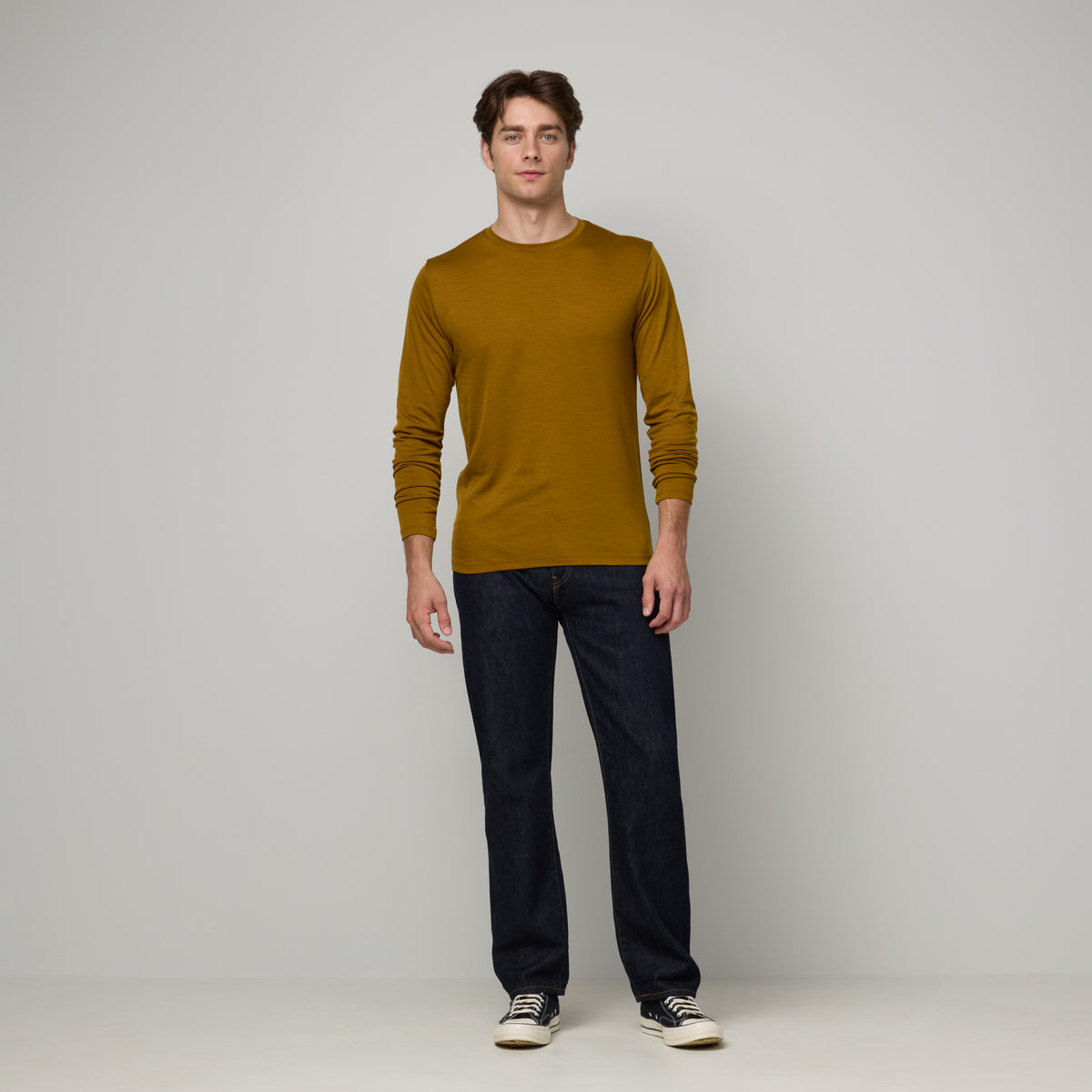 Laydown of merino wool Signature Long Sleeve Tee in Spiced Pear, a dark mustard color. This is a long sleeve, crew neck tee available in sizes XS-XXL. 