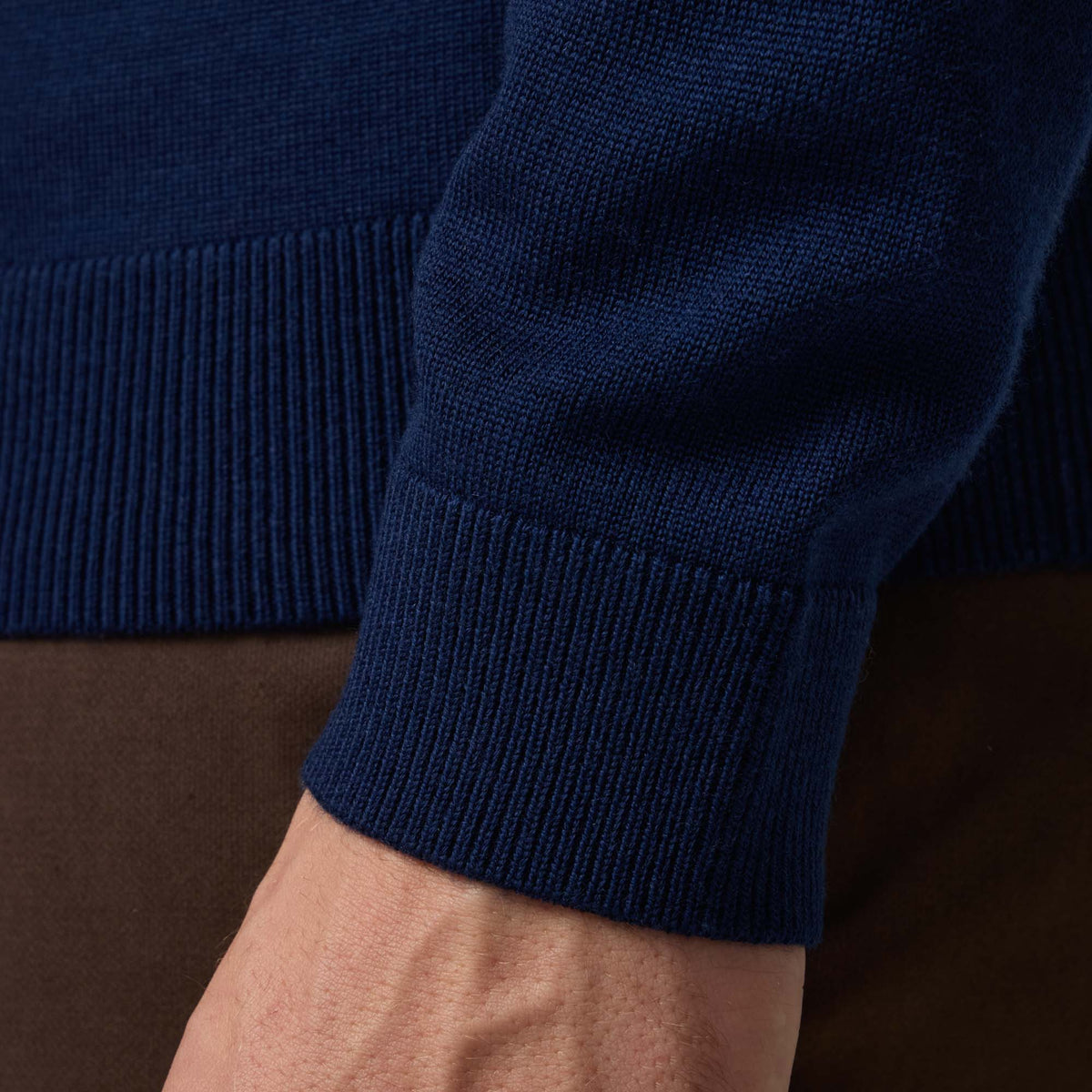 Detail of 100% merino wool Crew Neck Sweater in Navy. This is a knit available in sizes S-XXL.