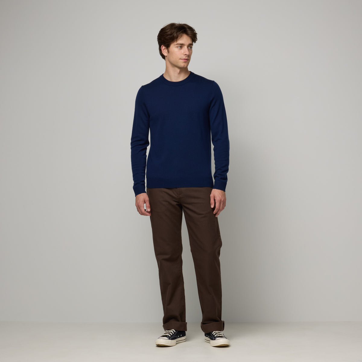 Model wearing 100% merino wool Crew Neck Sweater in Navy. This is a knit available in sizes S-XXL.