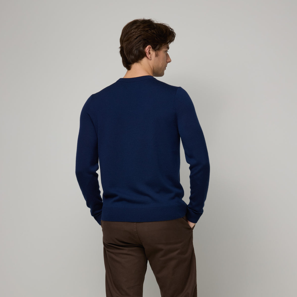 Model wearing 100% merino wool Crew Neck Sweater in Navy. This is a knit available in sizes S-XXL.