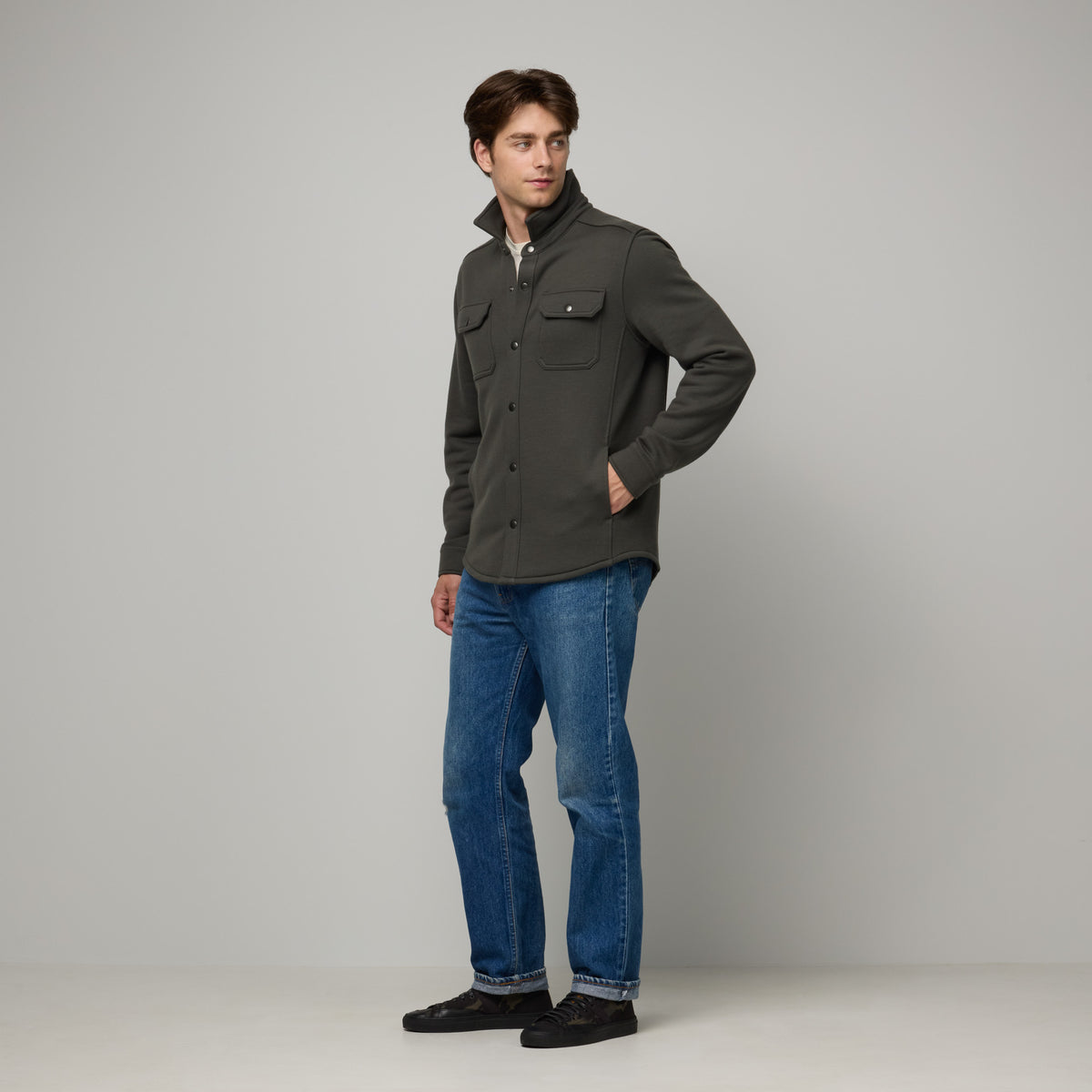 Model wearing Brushback Shacket in Forest Night, a dark forest green color. This is a 100% merino wool jacket available in sizes XS-XXL.