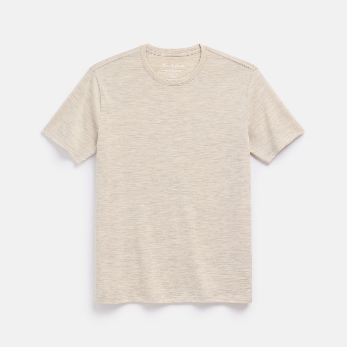 Laydown of merino wool Signature Crew Neck Tee in Oatmeal Heather, a heathered cream color. This is a short sleeve, crew neck tee available in sizes XS-2X