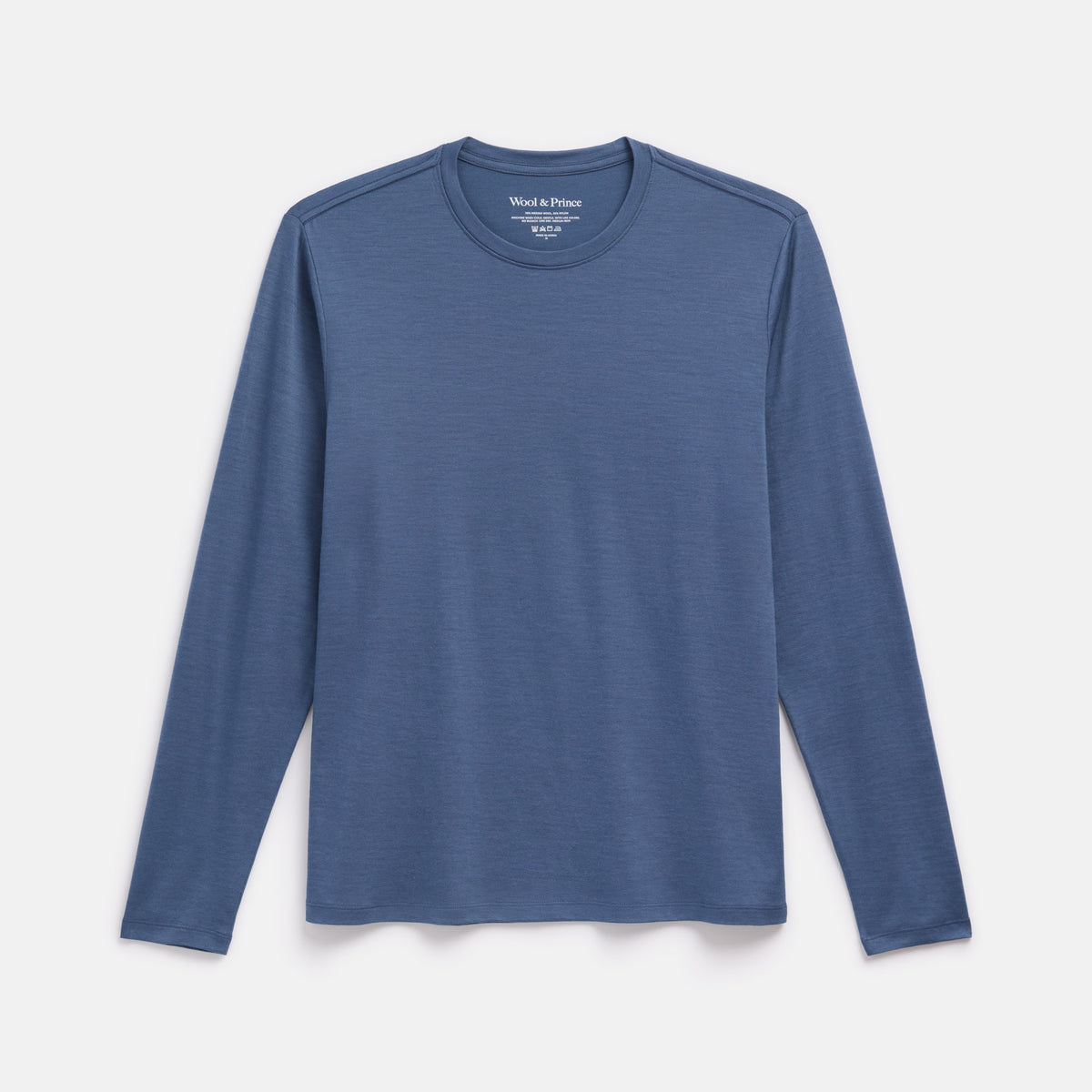 Laydown of merino wool Signature Long Sleeve Tee in Vintage Blue, a dusty blue color. This is a long sleeve, crew neck tee available in sizes XS-XXL. 