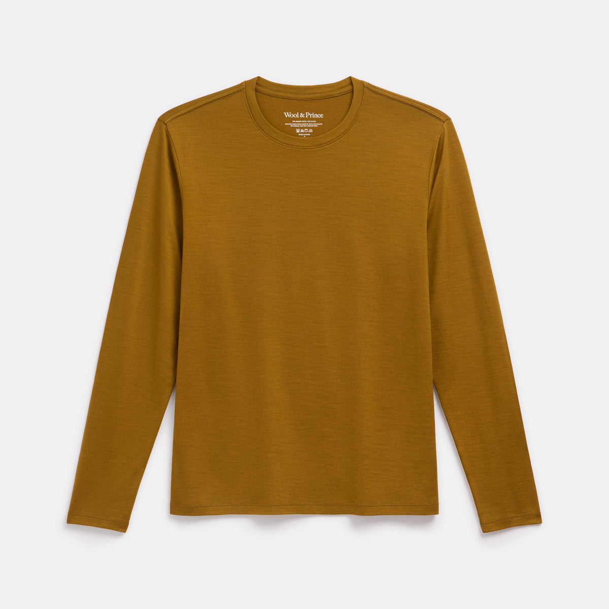 Laydown of merino wool Signature Long Sleeve Tee in Spiced Pear, a dark mustard color. This is a long sleeve, crew neck tee available in sizes XS-XXL. 