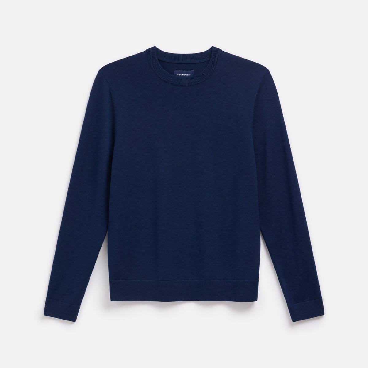 Laydown of 100% merino wool Crew Neck Sweater in Navy. This is a knit available in sizes S-XXL.