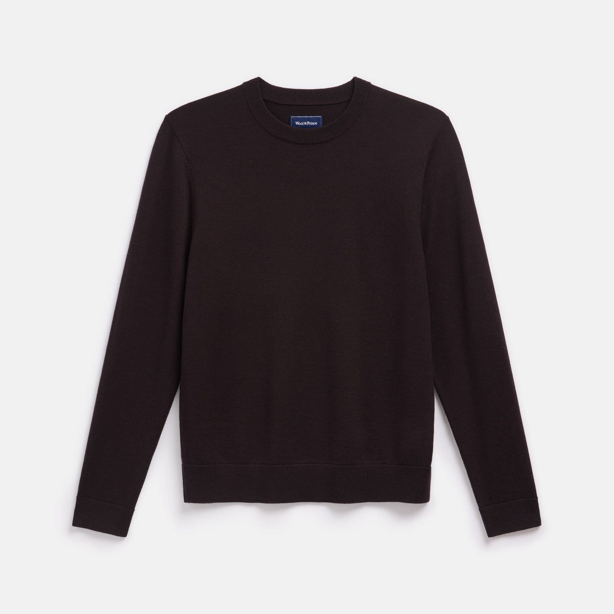 Laydown of 100% merino wool Crew Neck Sweater in Espresso, a dark brown color. This is a knit available in sizes S-XXL.