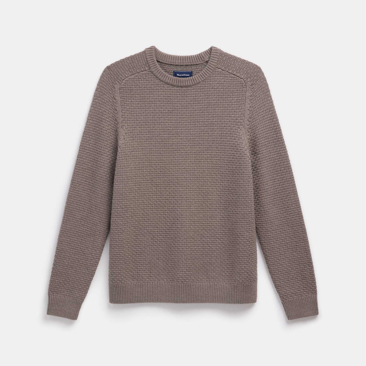 Model wearing 100% merino wool Textured Crew Neck Sweater in Brown Heather, a taupe brown color. This is a knit available in sizes S-XXL.